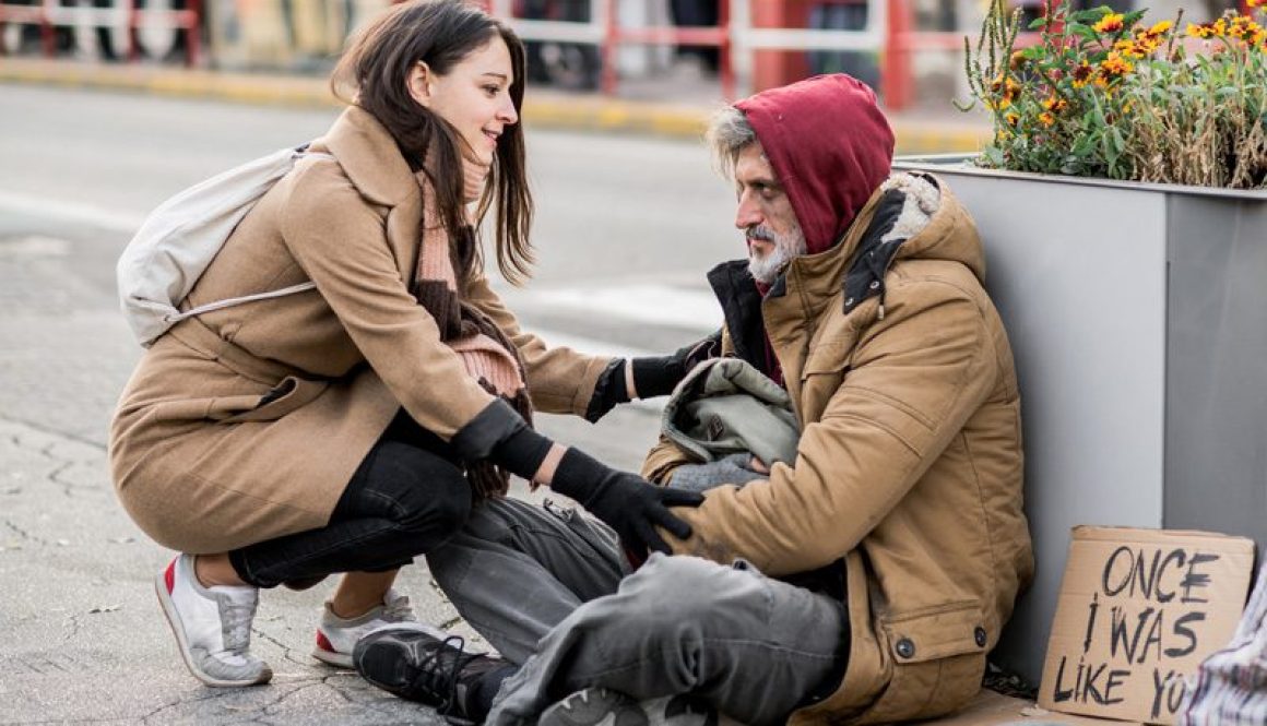 young-woman-giving-money-to-homeless-beggar-man